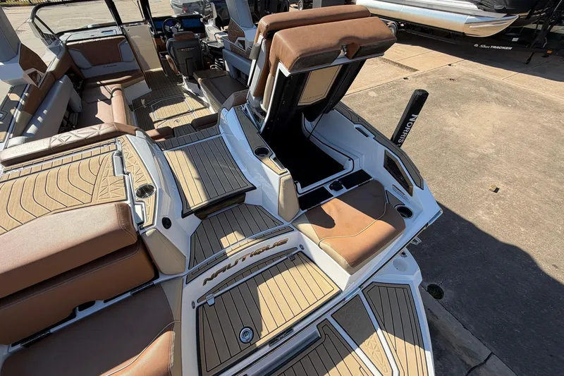 Slide: The Image of 2022 Nautique Super Air Nautique G25 Paragon interior with luxurious seating and storage. - 76