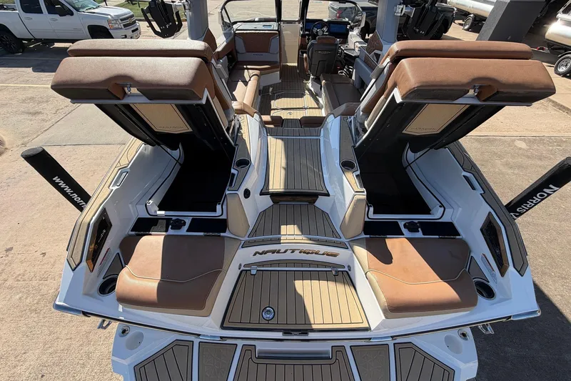 Slide: The Image of 2022 Nautique Super Air Nautique G25 Paragon boat interior with luxurious seating and deck. - 77