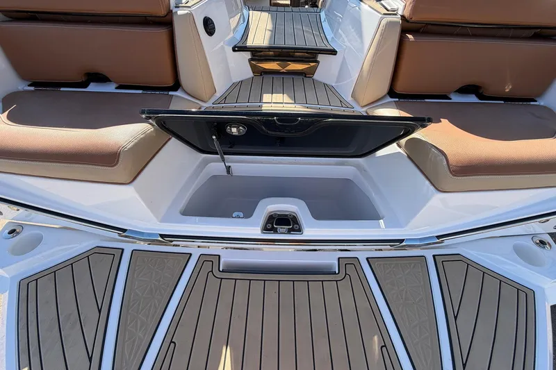 Slide: The Image of 2022 Nautique Super Air Nautique G25 Paragon interior with open storage compartment and cushioned seating. - 79
