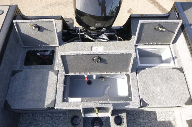 Slide: The Image of 2026 Tracker Targa V-19 Combo boat interior with storage compartments and motor. - 10