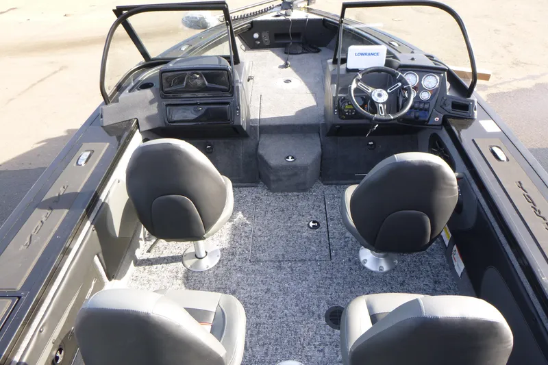 Slide: The Image of 2026 Tracker Targa V-19 Combo boat interior with four seats and steering console. - 13