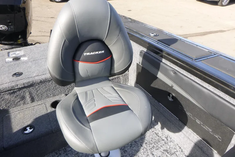 Slide: The Image of 2026 Tracker Targa V-19 Combo boat storage compartment with orange case inside. - 14