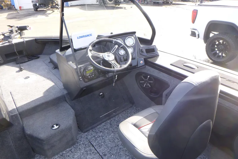 Slide: The Image of 2026 Tracker Targa V-19 Combo boat storage compartment with organized tackle boxes. - 18