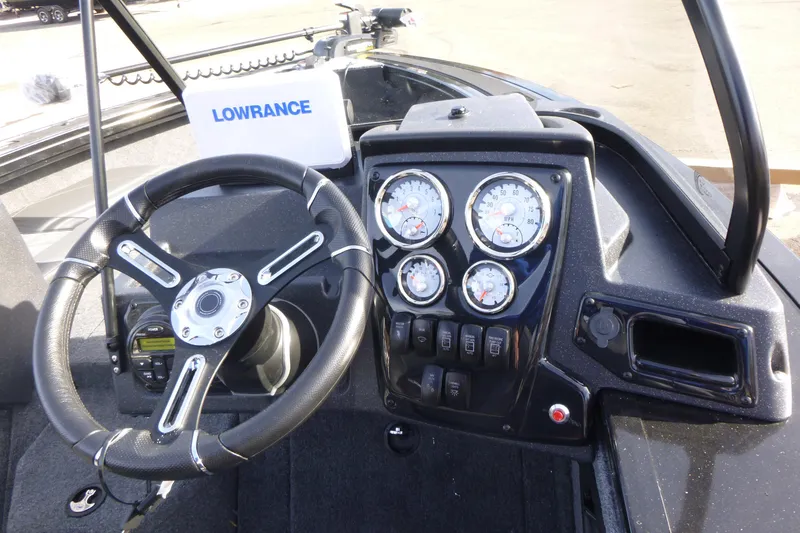 Slide: The Image of 2026 Tracker Targa V-19 Combo boat interior with steering console and seating. - 19