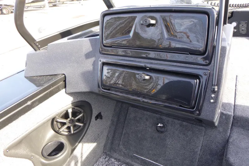 Slide: The Image of 2026 Tracker Targa V-19 Combo boat interior with storage compartments and speaker. - 24