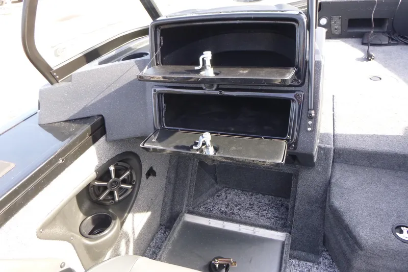 Slide: The Image of 2026 Tracker Targa V-19 Combo boat interior with storage compartments and speaker. - 25