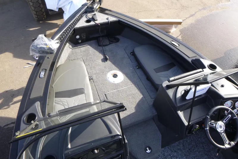 Slide: The Image of 2026 Tracker Targa V-19 Combo boat interior with seating and steering console. - 30