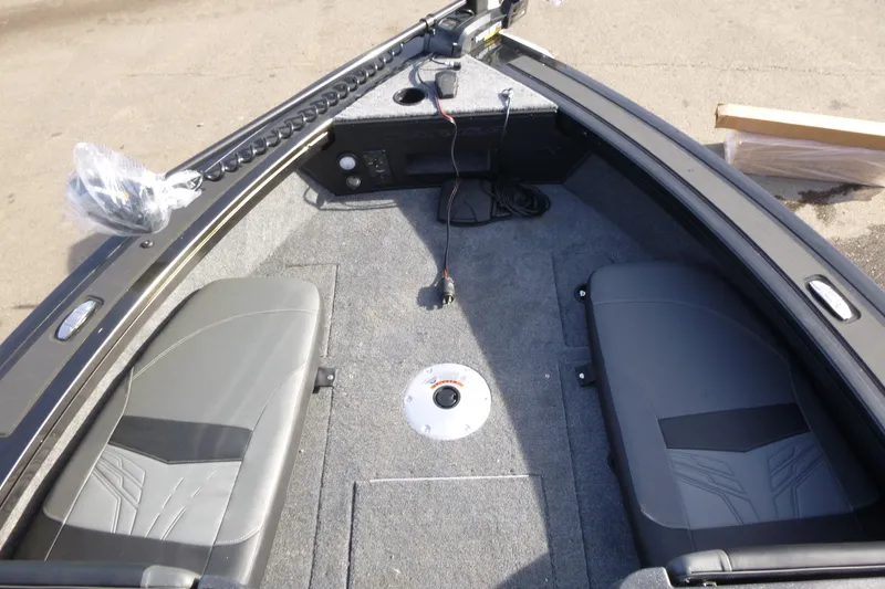 Slide: The Image of 2026 Tracker Targa V-19 Combo boat interior with gray seating and carpeted floor. - 31
