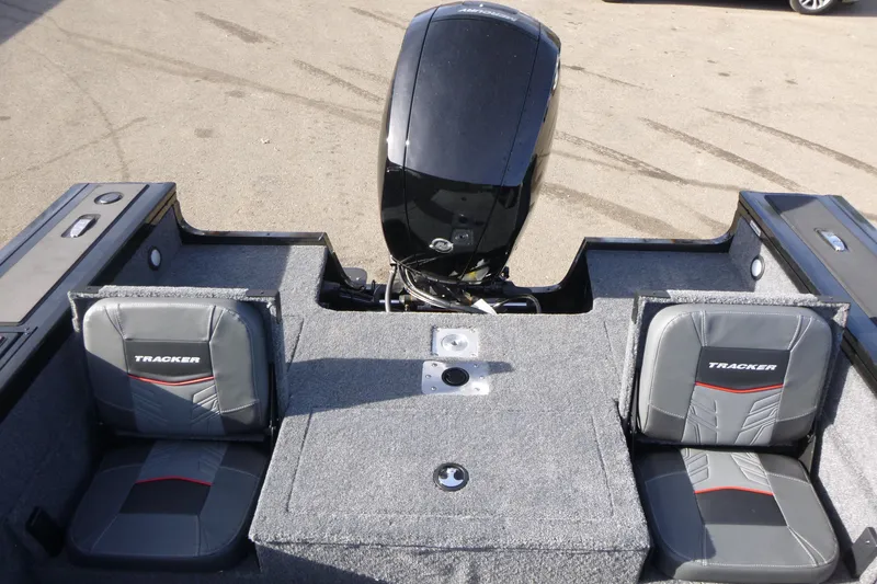 Slide: The Image of 2026 Tracker Targa V-19 Combo boat interior with green navigation light and water bottle. - 8