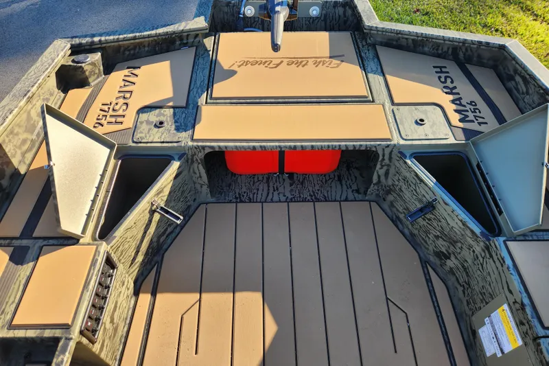 Slide: The Image of 2026 Tracker Grizzly 1756 T Marsh boat interior with storage compartments open. - 14