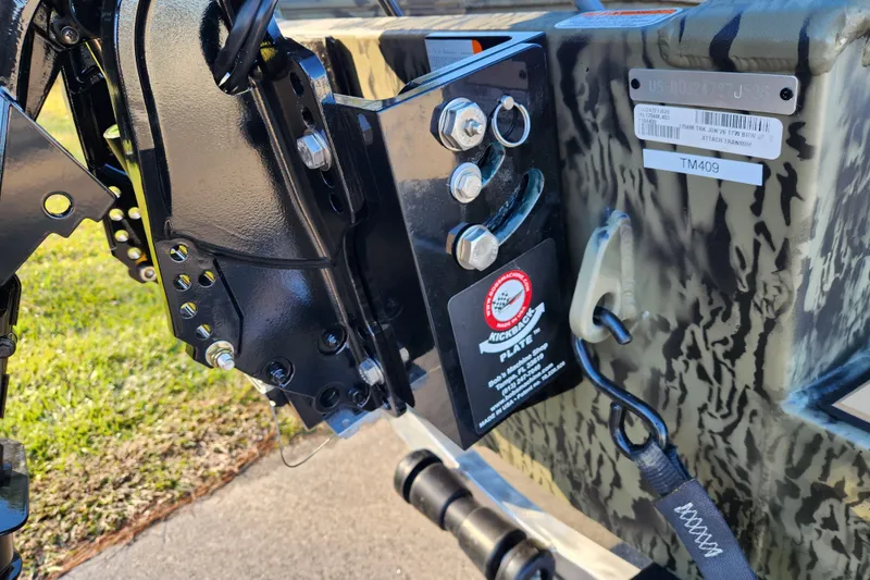 Slide: The Image of 2026 Tracker Grizzly 1756 T Marsh boat detail, featuring robust metal components and camouflage design. - 16