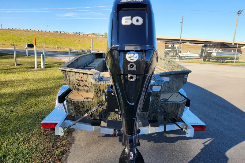 Slide: The Image of 2026 Tracker Grizzly 1756 T Marsh boat with Mercury 60 engine, parked outdoors. - 3