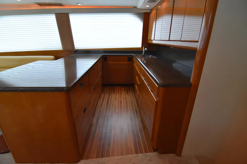 Slide: The Image of Luxurious kitchen interior of 1999 Viking 58 Convertible yacht with wooden cabinetry. - 17