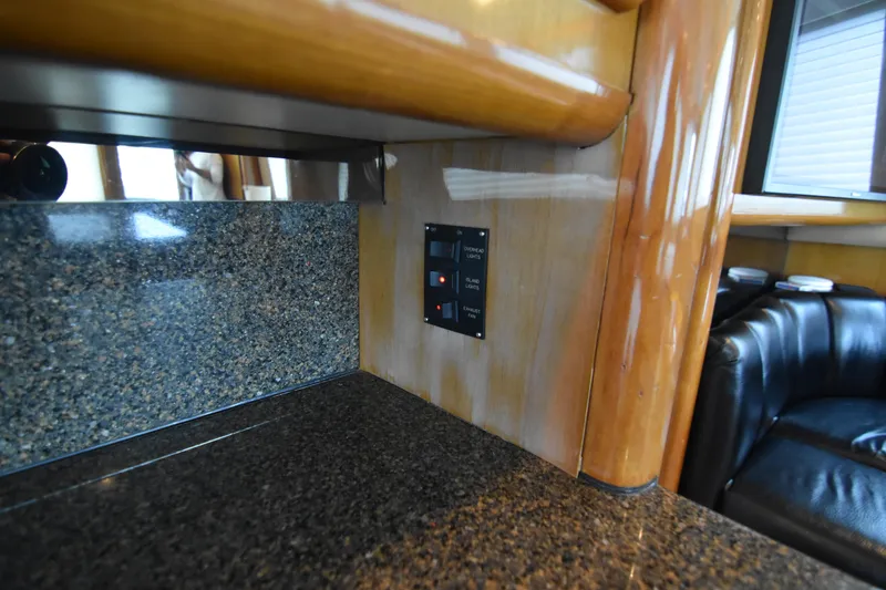 Slide: The Image of Interior of 1999 Viking 58 Convertible yacht with granite countertop and control panel. - 19