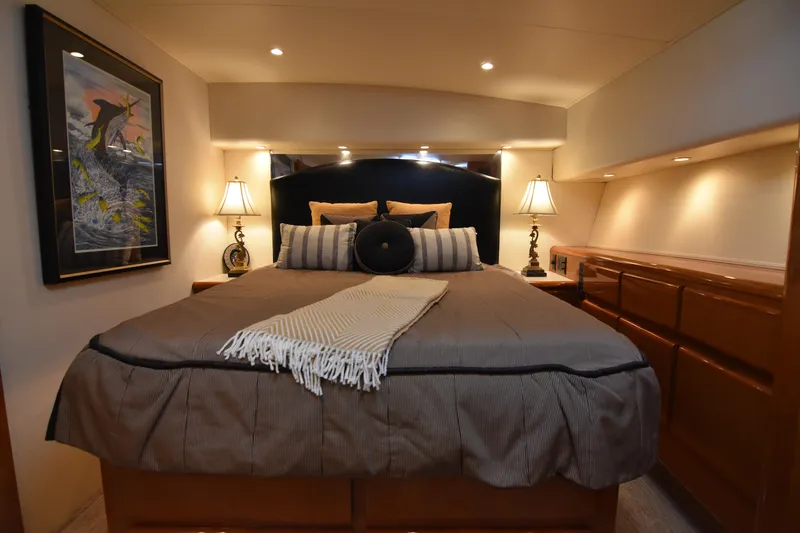 Slide: The Image of Luxurious bedroom interior of a 1999 Viking 58 Convertible yacht with elegant decor. - 20