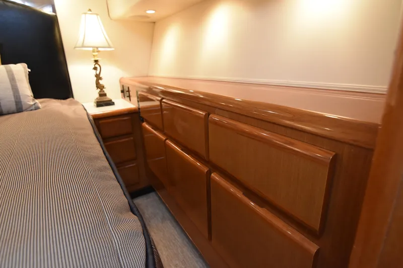 Slide: The Image of Luxurious interior of 1999 Viking 58 Convertible yacht with elegant wood cabinetry and ambient lighting. - 24