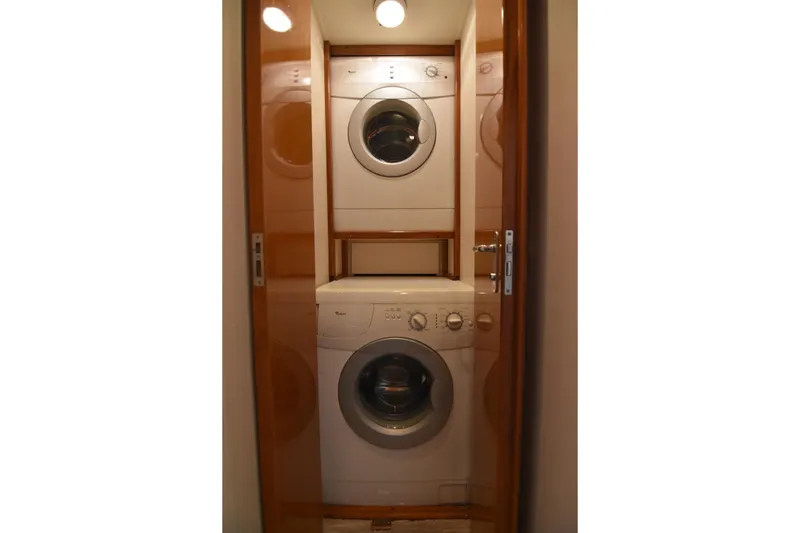 Slide: The Image of Stacked washer and dryer inside 1999 Viking 58 Convertible yacht. - 30