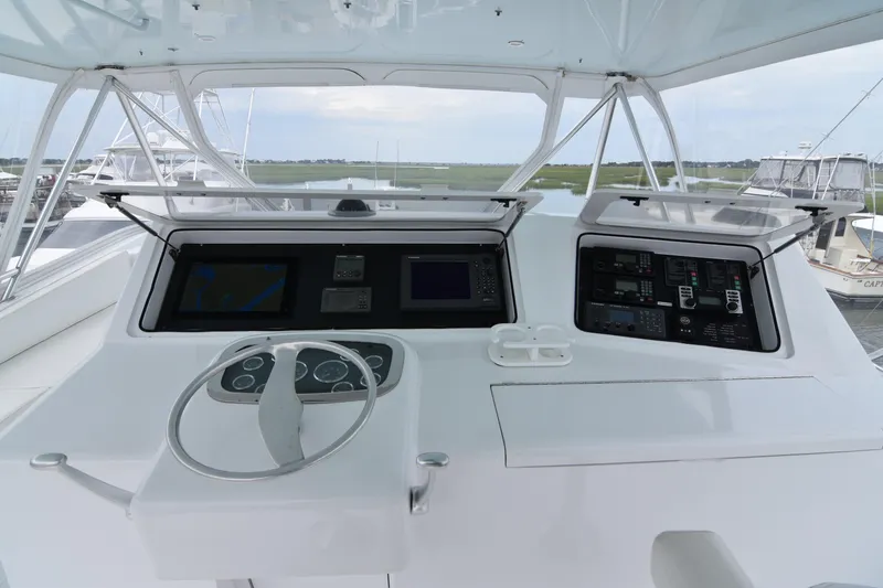 Slide: The Image of 1999 Viking 58 Convertible yacht helm with navigation controls and steering wheel. - 31