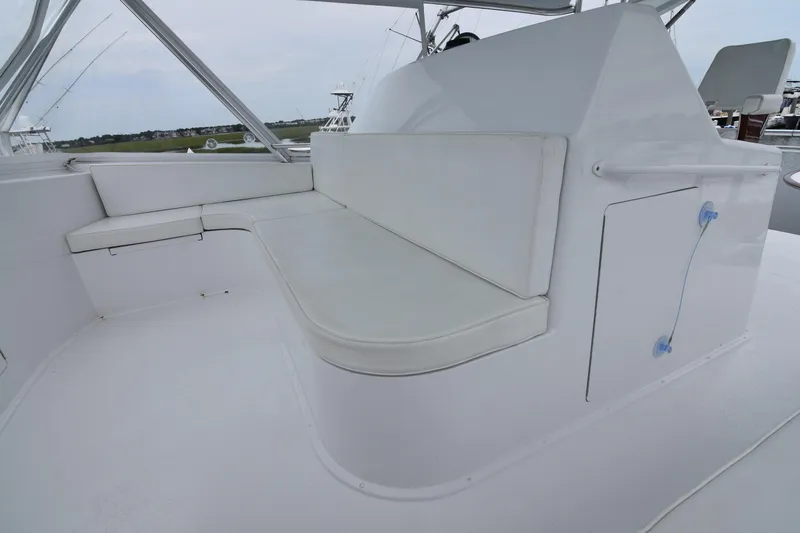 Slide: The Image of 1999 Viking 58 Convertible yacht interior with white cushioned seating area. - 35