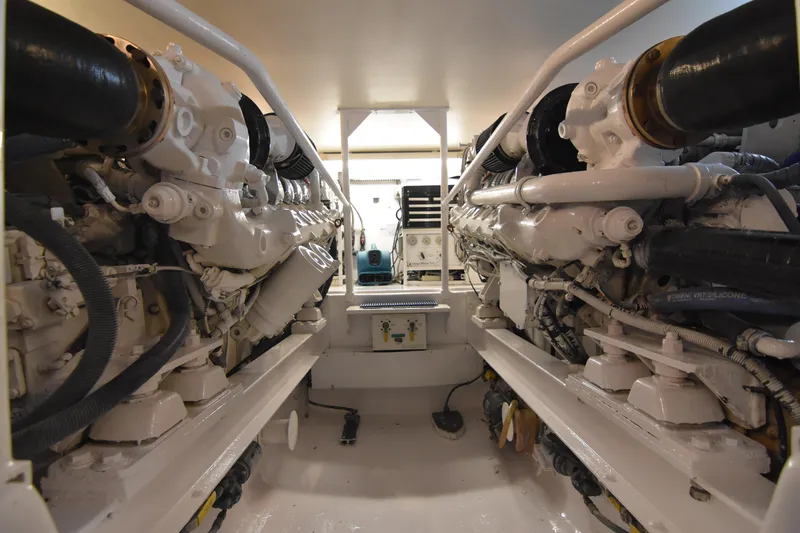 Slide: The Image of Engine room of a 1999 Viking 58 Convertible yacht, showcasing dual engines. - 36
