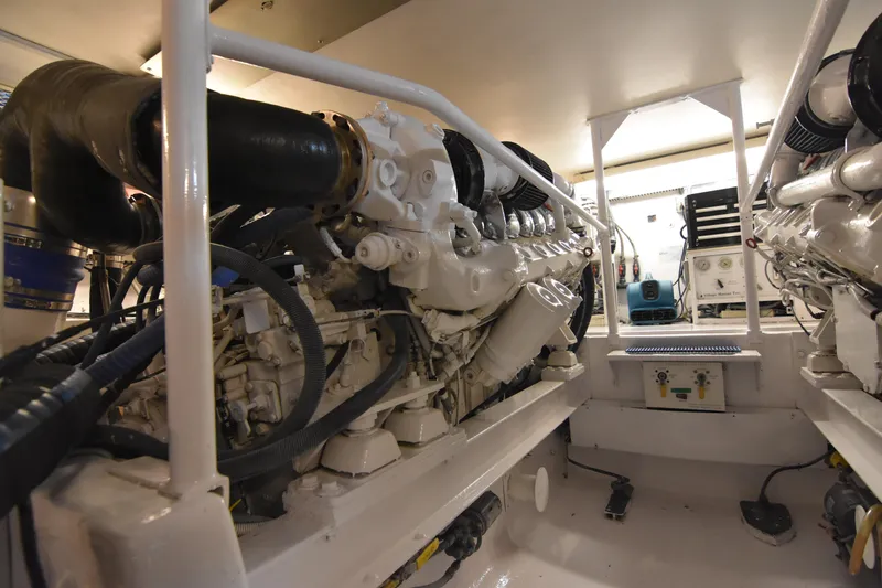 Slide: The Image of Engine room of 1999 Viking 58 Convertible yacht, showcasing powerful machinery and equipment. - 37