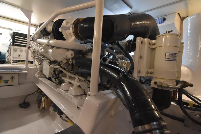Slide: The Image of Engine room of a 1999 Viking 58 Convertible yacht, showcasing mechanical components. - 38
