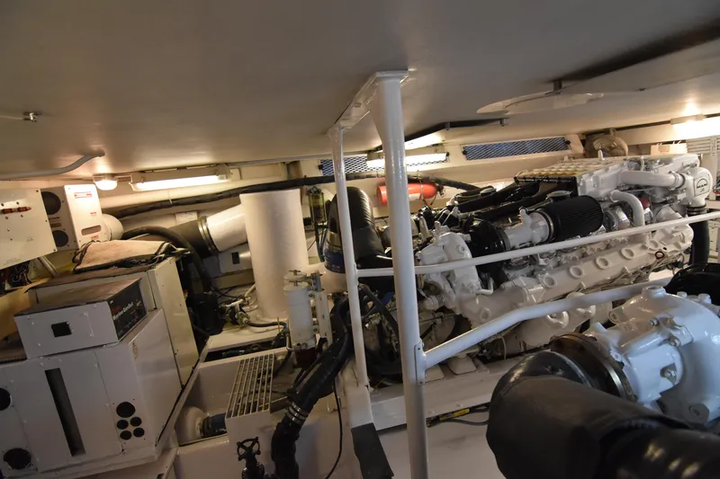 Slide: The Image of Engine room of a 1999 Viking 58 Convertible yacht, showcasing machinery and equipment. - 40
