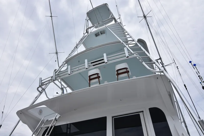 Slide: The Image of 1999 Viking 58 Convertible yacht tower with ladders and railings against cloudy sky. - 7