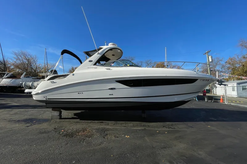 The Image of 2016 Sea Ray 310 Sundancer boat on display under clear blue sky. - 0