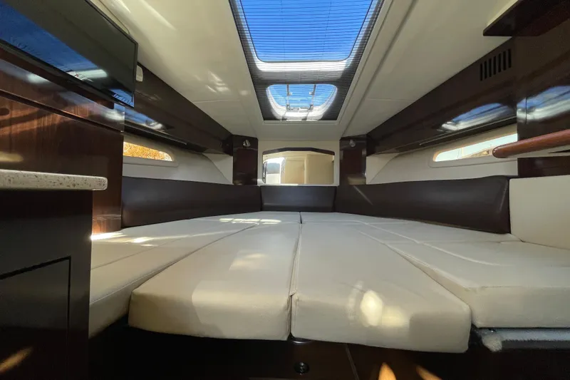 Slide: The Image of Interior of 2016 Sea Ray 310 Sundancer yacht with spacious seating and skylight. - 12