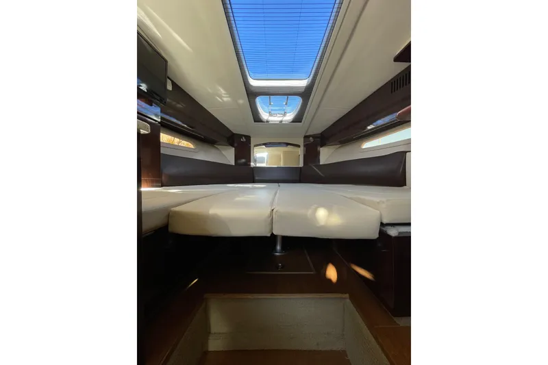 Slide: The Image of Interior cabin of 2016 Sea Ray 310 Sundancer with skylight and seating area. - 13