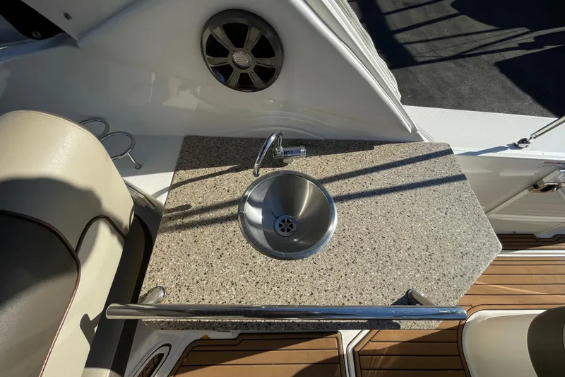 Slide: The Image of 2016 Sea Ray 310 Sundancer boat with granite countertop and stainless steel sink. - 16
