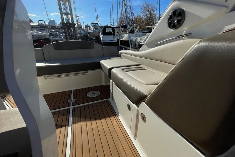 Slide: The Image of 2016 Sea Ray 310 Sundancer interior with cushioned seating and wooden flooring. - 17