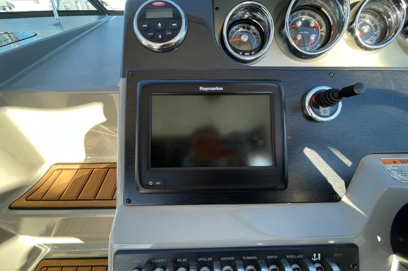 Slide: The Image of Control panel of 2016 Sea Ray 310 Sundancer with Raymarine display and gauges. - 18