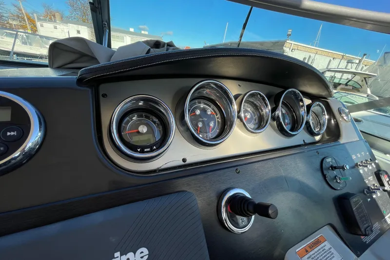 Slide: The Image of Dashboard of a 2016 Sea Ray 310 Sundancer boat with gauges and controls. - 19