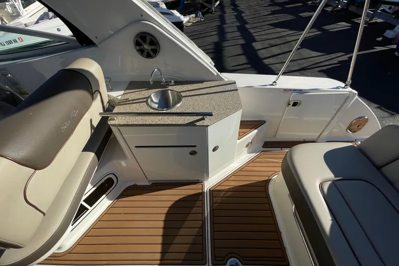 Slide: The Image of Luxurious 2016 Sea Ray 310 Sundancer boat interior with sink and seating area. - 20
