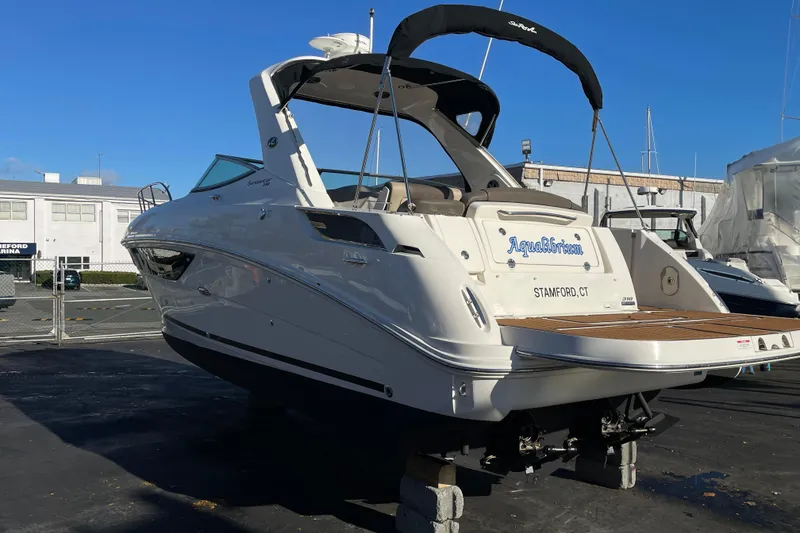 Slide: The Image of 2016 Sea Ray 310 Sundancer boat on display at a marina. - 23