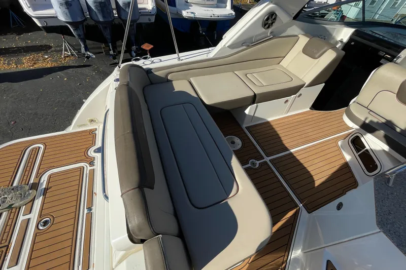 Slide: The Image of 2016 Sea Ray 310 Sundancer boat interior with cushioned seating and teak flooring. - 24