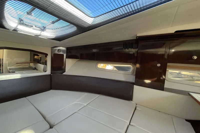 Slide: The Image of Interior of 2016 Sea Ray 310 Sundancer with modern furnishings and skylight. - 3