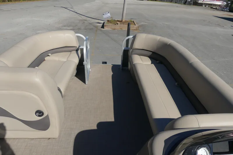 Slide: The Image of 2023 Sun Tracker Party Barge 18 DLX interior with beige seating and spacious layout. - 3