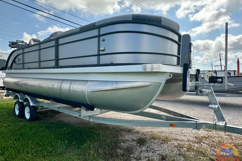 The Image of 2024 Massimo P-21R pontoon boat on trailer, parked outdoors under a blue sky. - 0