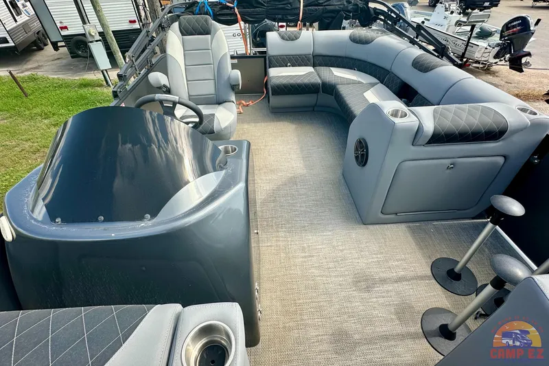 Slide: The Image of 2024 Massimo P-21R pontoon boat interior with gray seating and steering console. - 10
