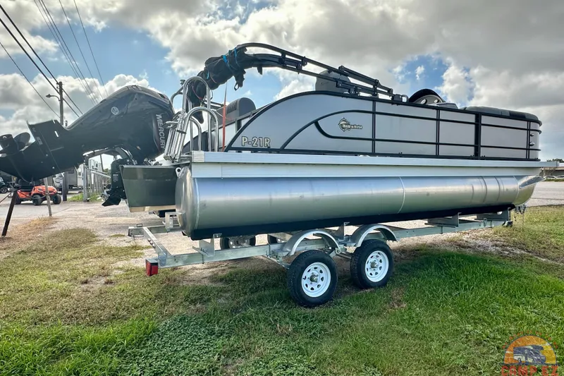 Slide: The Image of 2024 Massimo P-21R pontoon boat on trailer under cloudy sky. - 3