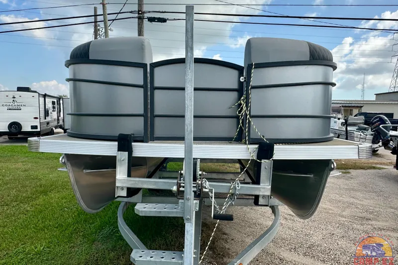 Slide: The Image of 2024 Massimo P-21R pontoon boat on trailer, parked outdoors. - 6