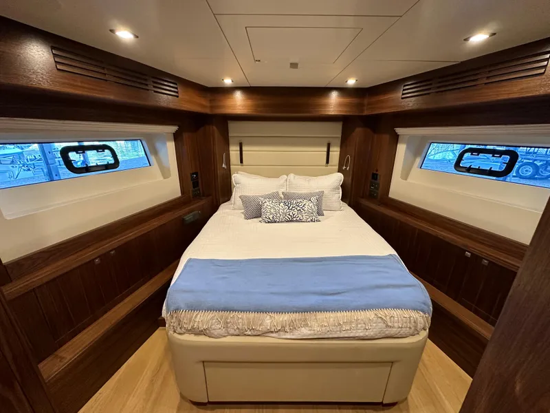 Slide: The Image of Luxurious bedroom interior of 2021 Sirena 58 yacht with cozy bed and elegant wood finish. - 37