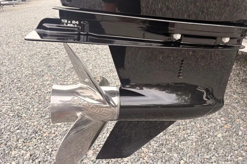 Slide: The Image of Close-up of a 2023 Crest Classic LX 220 SLRC boat propeller on gravel surface. - 10