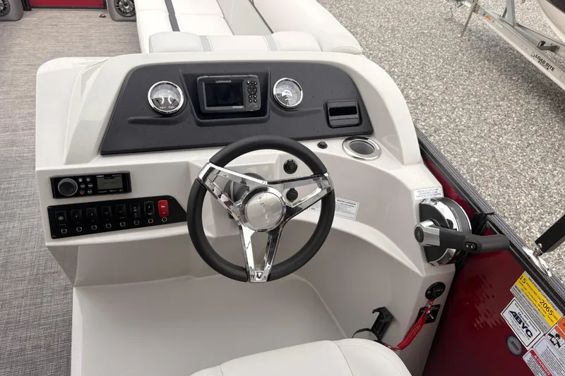 Slide: The Image of 2023 Crest Classic LX 220 SLRC boat dashboard with steering wheel and controls. - 14