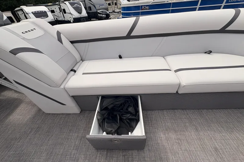 Slide: The Image of 2023 Crest Classic LX 220 SLRC boat interior with storage drawer open. - 20