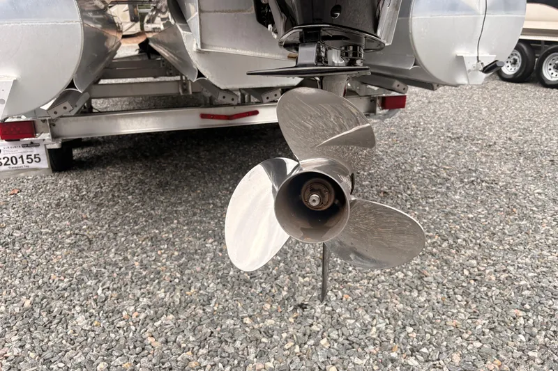 Slide: The Image of 2023 Crest Classic LX 220 SLRC boat propeller on gravel surface. - 24