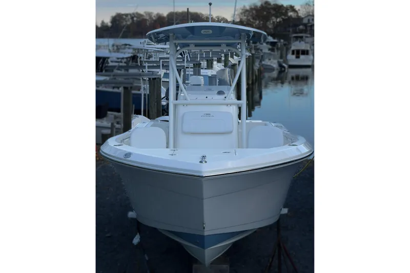 Slide: The Image of 2020 Cobia 220 Center Console boat docked at marina, front view. - 10